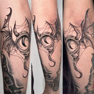 Experience a unique blend of dotwork and fine line technique in this illustrative tattoo featuring a mystical bat with one eye and the symbol of aliman, created by the talented artist Claudia Whiteheart