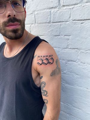 Get a sleek and stylish number tattoo with expertly crafted lettering by renowned artist Charlie Macarthur.