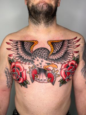 Get a bold and classic traditional tattoo featuring an eagle, rose, and heart designed by the talented artist Claudia Trash.