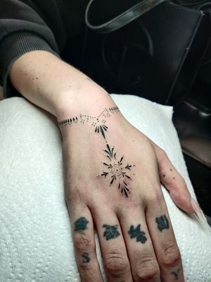 Elegantly intricate design by tattoo artist Mary Shalla, perfect for a subtle yet stunning hand tattoo. 