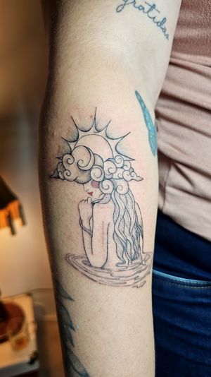 Elegant fine line tattoo featuring a woman among clouds and sun, beautifully crafted by tattoo artist Katia Barria.