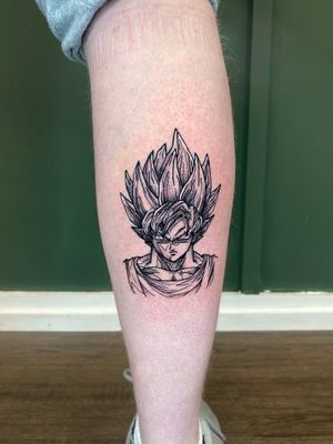 Epic tattoo featuring Goku from Dragon Ball series, done by the talented artist Liam Collins.
