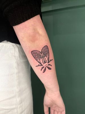 Get a captivating illustrative tattoo of a moth with unique woodcut and etching details by artist Liam Collins.
