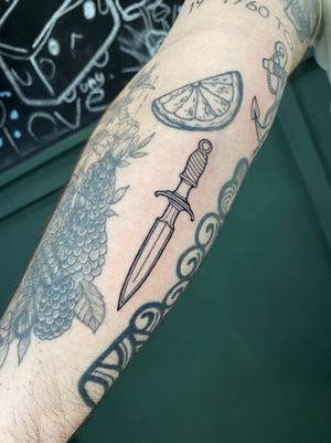 Get a unique and intricate dagger tattoo with fine lines and illustrative details, expertly done by Liam Collins.