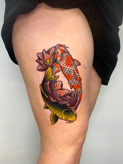 Liam Collins expertly blends Japanese and neo-traditional styles to create a stunning tattoo featuring a vibrant koi fish swimming among delicate lotus flowers.