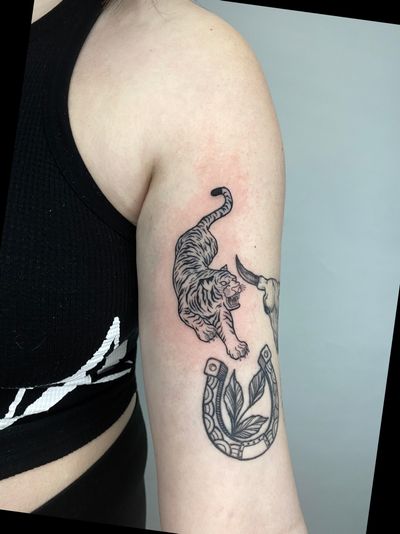 Roar with confidence with this stunning illustrative tiger tattoo by tattoo artist Liam Collins. Perfect for those who embody strength and power.