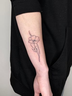 Beautiful flower design by talented artist Liam Collins, perfect for those wanting a delicate and stylish tattoo.