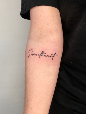 Express yourself with a minimalist small lettering tattoo by artist Liam Collins on your forearm.