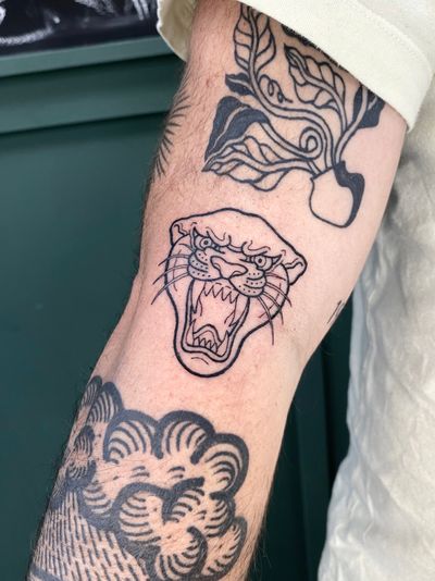Get a fierce and timeless panther tattoo with bold illustrative style by talented artist Liam Collins.