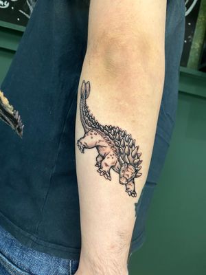 Get a unique, detailed ankylosaurus tattoo in dotwork style by the talented artist Liam Collins.