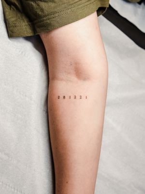 Express your uniqueness with this elegant small lettering number tattoo by Gabriele Edu. Perfect for a subtle yet meaningful touch.