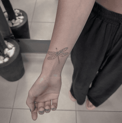 Get a stunning dragonfly tattoo on your wrist by the talented artist Monike. Embrace the beauty of nature with this unique design.