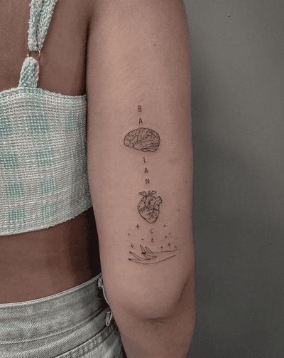 Express your inner conflict with this unique ignorant style tattoo featuring a heart and brain on your arm. Created by the talented artist Monike.