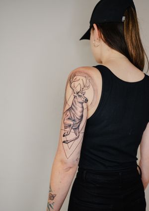 Fine line black and gray illustrative tattoo of a geometric buck designed by Gabriele Edu.