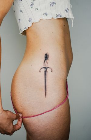 Gabriele Edu's illustrative black and gray tattoo of a detailed dagger design is a true work of art.