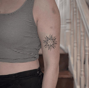 Get a beautifully detailed illustrative sun tattoo by Monike, crafted with fine line technique for a delicate and intricate look.