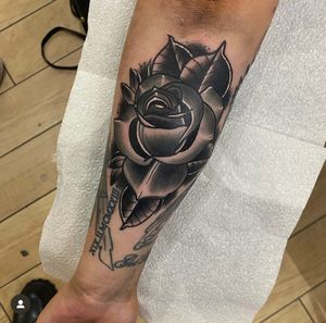 Experience timeless beauty with this classic traditional rose tattoo expertly crafted by Katy Sarsfield.