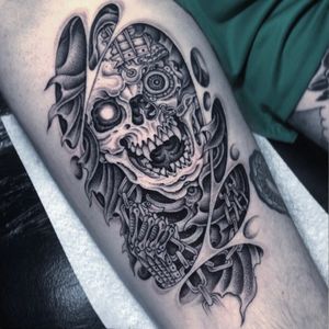 Get inked with a stunning dotwork and illustrative tattoo of a skull merged with bio mechanical elements by the talented artist Gianluca Fusco.