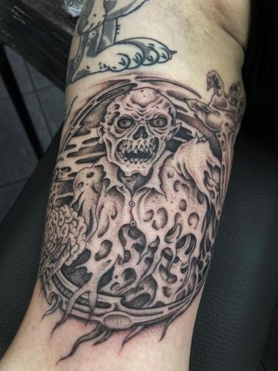 Experience the hauntingly beautiful blend of dotwork and illustrative styles in this eerie zombie ghoul tattoo by Gianluca Fusco.