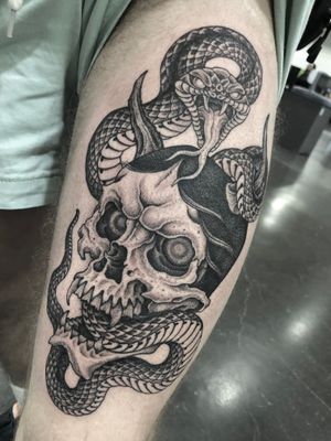 Get inked with a striking illustrative design of a snake entwined with a skull by Gianluca Fusco. A unique combination of danger and mystery.