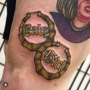 Adorn your knee with Katy Sarsfield's exquisite neo traditional tattoo featuring elegant hoop earrings.