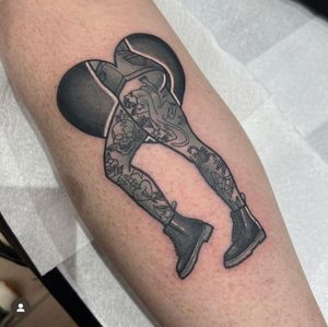 Stunning illustrative tattoo by Katy Sarsfield featuring a pin-up girl with a heart motif on the legs in shorts. Unique and eye-catching design.