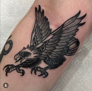 Fly high with this majestic falcon/hawk tattoo in classic traditional style, expertly executed by renowned artist Katy Sarsfield.