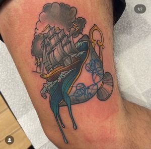 Voyage in style with this unique tattoo by Katy Sarsfield, combining a classic ship and whimsical teacup design on the upper leg.