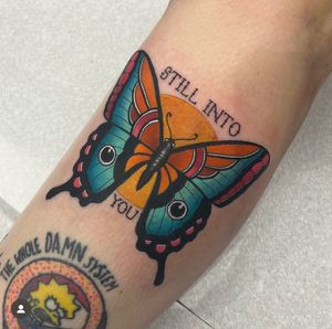 Vibrant lower arm tattoo by Katy Sarsfield featuring a beautifully detailed butterfly in a neo traditional style.