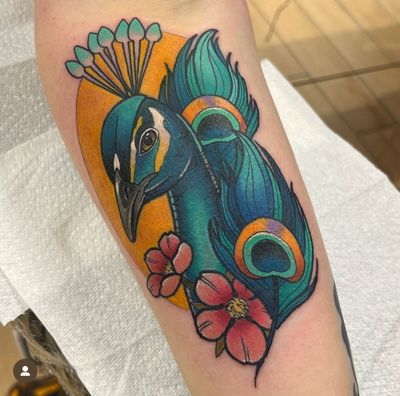 Vibrant peacock design on lower arm, expertly crafted in neo-traditional style by the talented artist Katy Sarsfield.