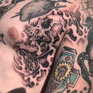 This black and gray dotwork tattoo features a detailed illustrative skull design by talented artist Gianluca Fusco.