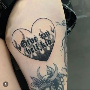 Unique dotwork tattoo featuring a heart with 'give 'em hell, kid' lettering and flames, expertly done by artist Katy Sarsfield.