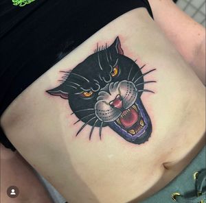Get inked with Katy Sarsfield's fierce panther design in a bold neo traditional style on your stomach. Roar with confidence!