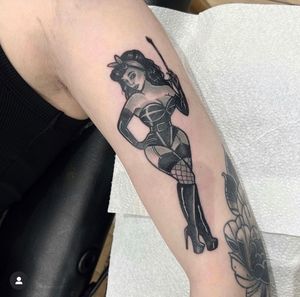Get timeless beauty with this traditional tattoo featuring a stunning pin up woman, expertly inked by Katy Sarsfield.