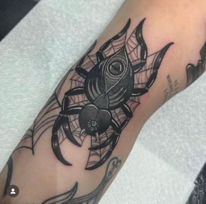 Get tangled in the intricate design of a classic spider and web tattoo by Katy Sarsfield. Perfect blend of illustrative style and traditional motifs.