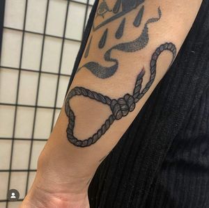 Capture the beauty and strength of love with this heart and rope tattoo, expertly designed by Katy Sarsfield. A timeless symbol of connection and unity.