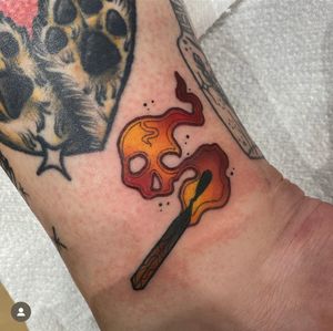Get a striking neo-traditional match tattoo on your wrist by the talented artist Katy Sarsfield.