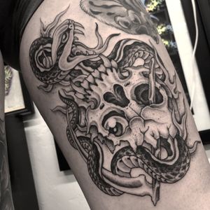 Get inked with an amazing illustrative traditional tattoo featuring a snake and skull, by the talented artist Gianluca Fusco.