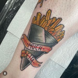 Vibrant lower leg tattoo by expert artist Katy Sarsfield, blending classic neo traditional style with a fun and tasty motif of chips and fries.