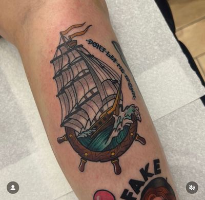 Get inked by Katy Sarsfield with a classic traditional ship design on your shin for a timeless look.