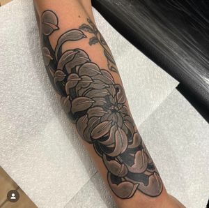 Experience the elegance of a Japanese peony in this intricate half sleeve tattoo by renowned artist Katy Sarsfield.