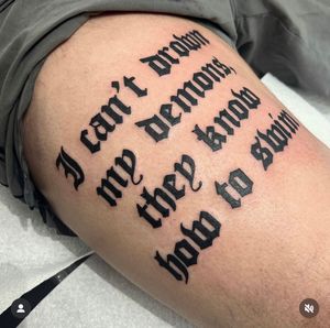 Get a striking script tattoo on your thigh by talented artist Katy Sarsfield for a unique and meaningful design.