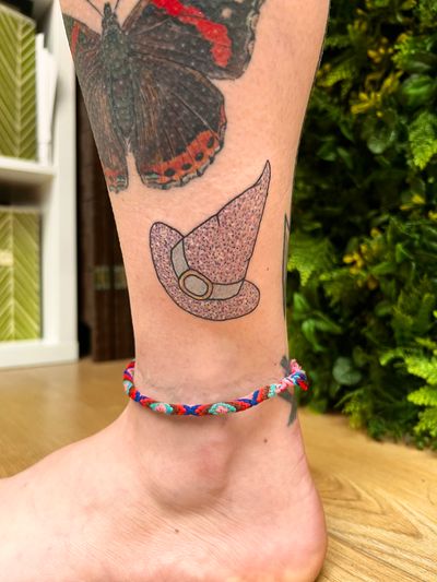 Get bewitched with this fine line, illustrative tattoo by Rachel Angharad. Adorned with glitter for an extra touch of magic.