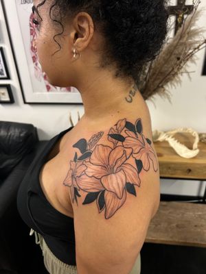 Stunning flower design by Jack Howard, perfect for a feminine touch on your shoulder. Embrace the beauty of nature with this delicate piece.