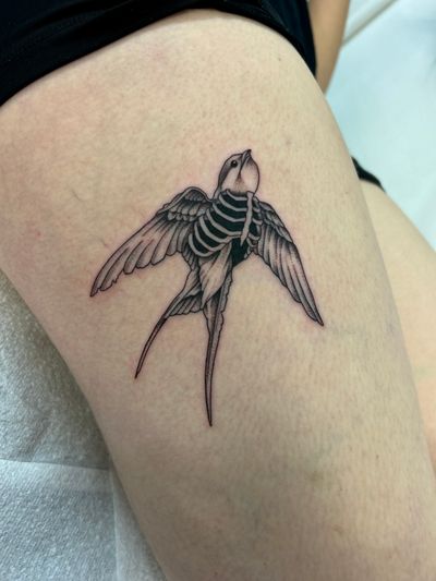 Get a unique illustrative tattoo of a horror-inspired swallow design by the talented artist Jack Howard.