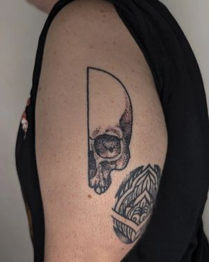 Experience the artistry of Alien Ink with this intricate blackwork skull tattoo, combining dotwork and hand-poke techniques.