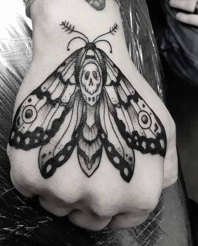 Illustrative blackwork tattoo of a moth, created by Elisa Thirteen, featuring intricate details and bold linework.