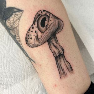 Explore the enchanting world of dotwork with this intricate mushroom tattoo by Jack Howard. A unique and timeless design.