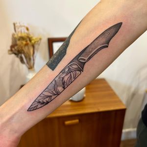 Get a striking dagger tattoo with detailed dotwork by renowned artist Jack Howard. This fine-line illustrative design is sure to make a statement.
