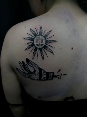 Get a unique illustrative tattoo featuring a sun and hand design done by talented artist Jess.
